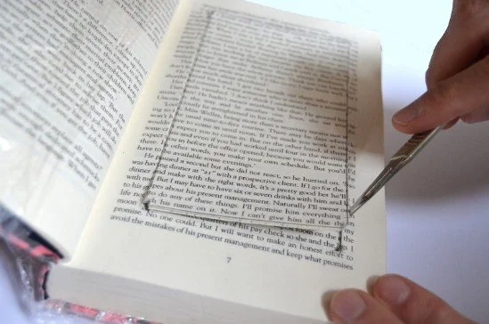 Create a Hidden Spot in the Library by Sticking All The Pages of a Book and Cropping the Middle