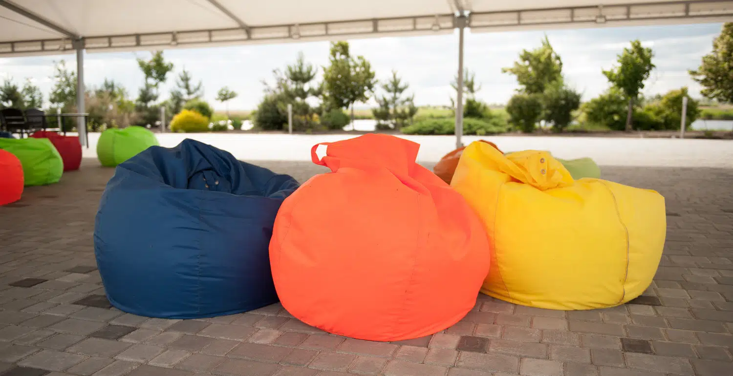 many colorful soft beanbag seats. under a canopy for relaxing