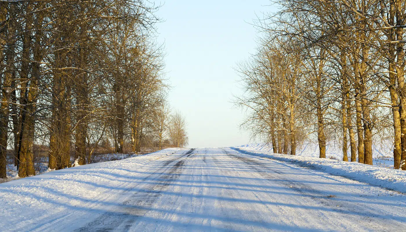 small road covered with snow in the winter season, Photo close-up with a shallow depth of field
