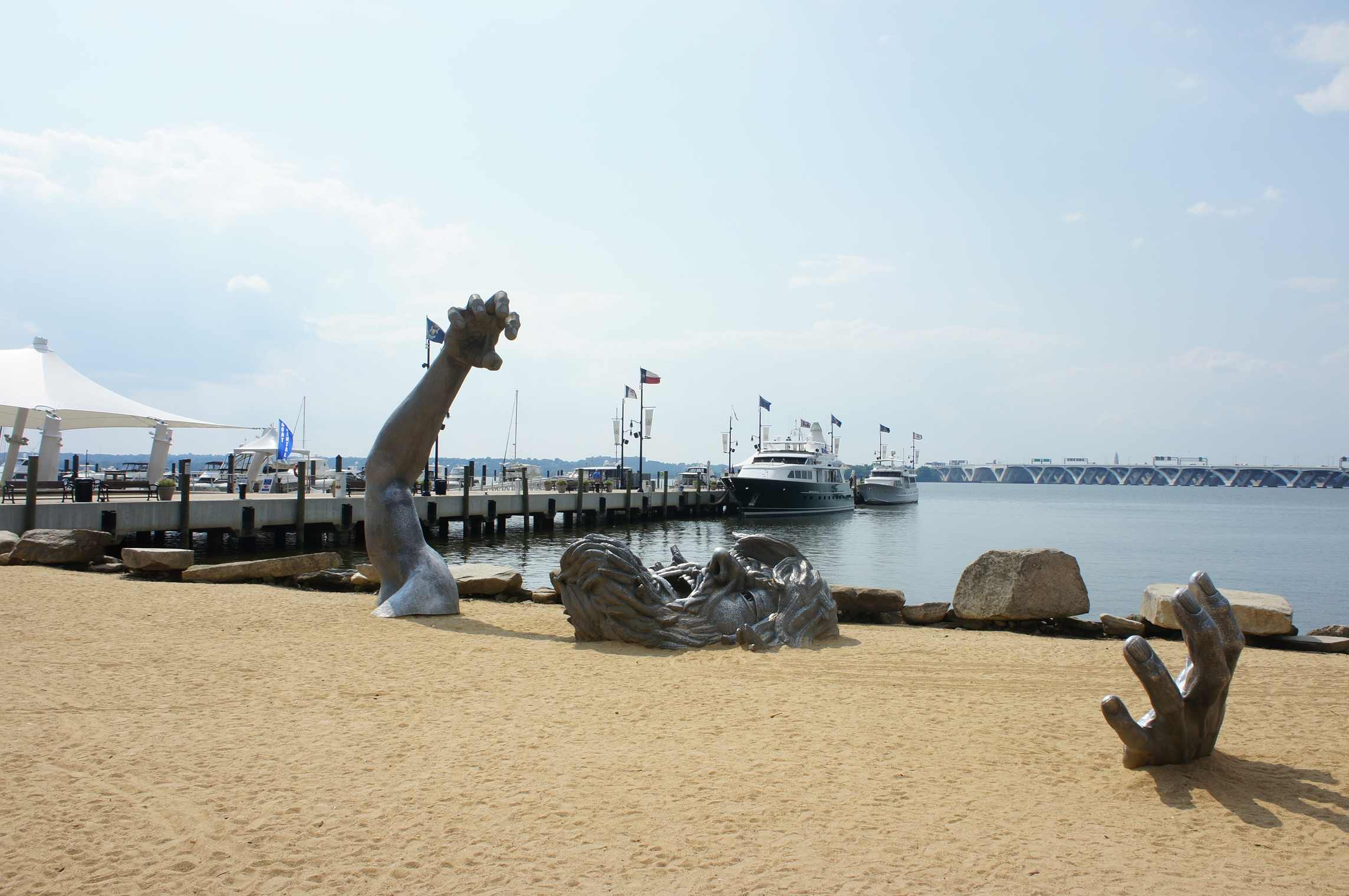 J. Seward Johnson Jr screaming statue contemporary art installation sculpture on sandy beach rising from the earth