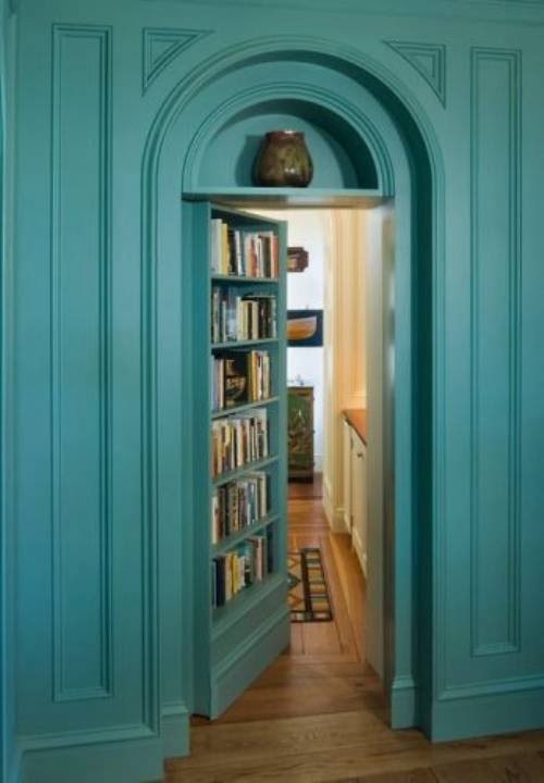 secret door pass trough the librabry in a interior design taht features tourqoise 