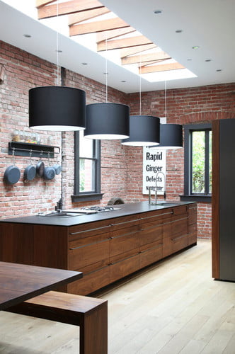 brick kitchen with wooden counter and raw unfinished touch