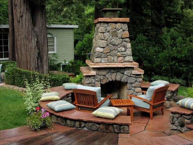 circular round stone fireplace by the swimming pool Backyard-Lanscaping-Ideas-Fireplaces-homesthetics
