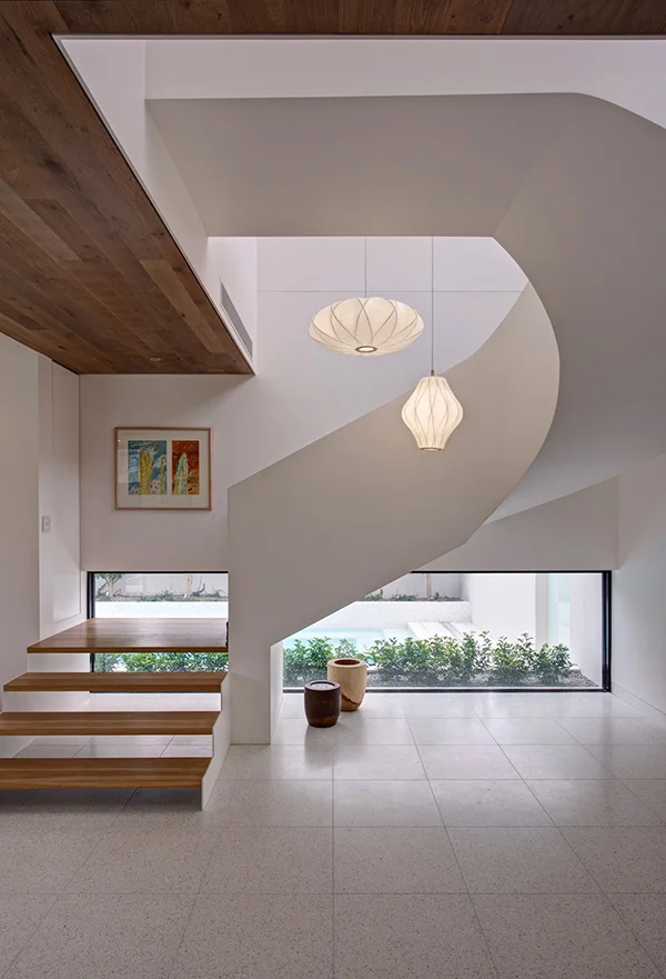 stark white sculptural staircase design expressed in a modern mansion