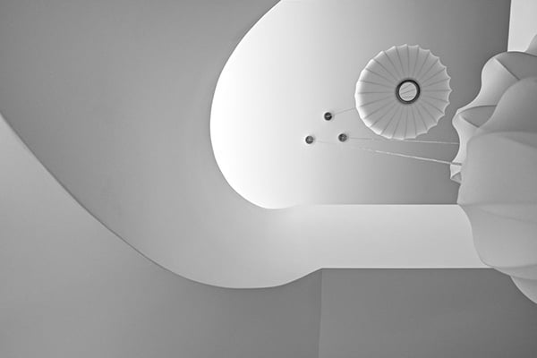 stark white sculptural staircase design expressed in a modern mansion