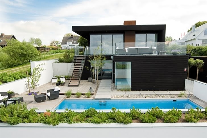 plain black facade Nilsson Villa-Modern Beach House With Black and White Interior Design in Sweden 