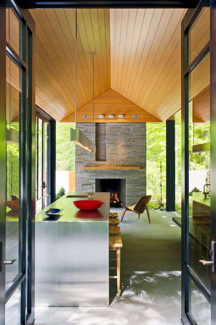 modern fireplace in the Supreme Backyard Landscaping Ideas-Nevis Pool and Garden Pavilion by Robert M. Gurney