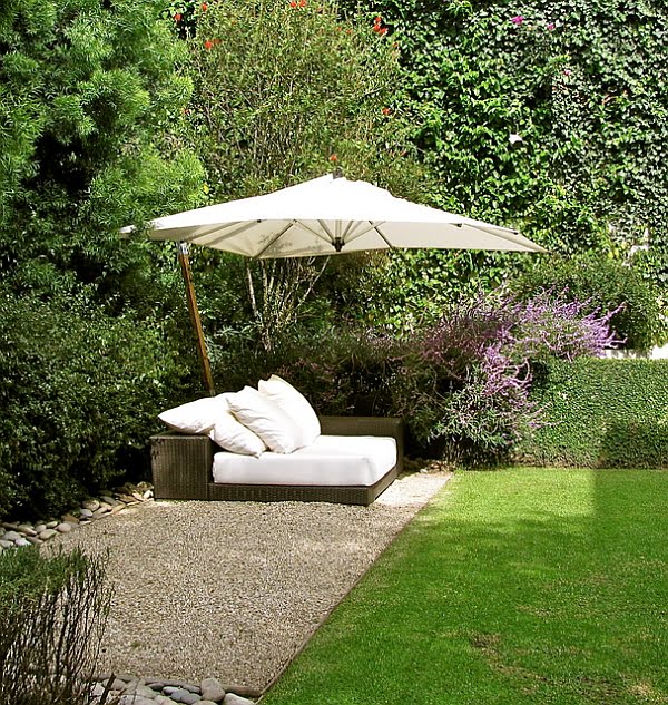 Stylish White Outdoor Bed Protected by a Umbrella in Tropical Style