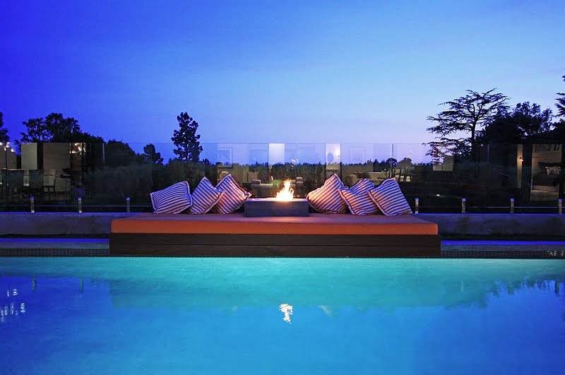 Outdoor Bed by the Pool and Fireplace
