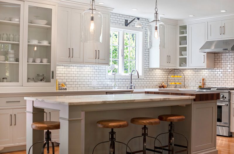 Apothecary Style Cabinets in a White Modern Kitchen with Vintage Chairs