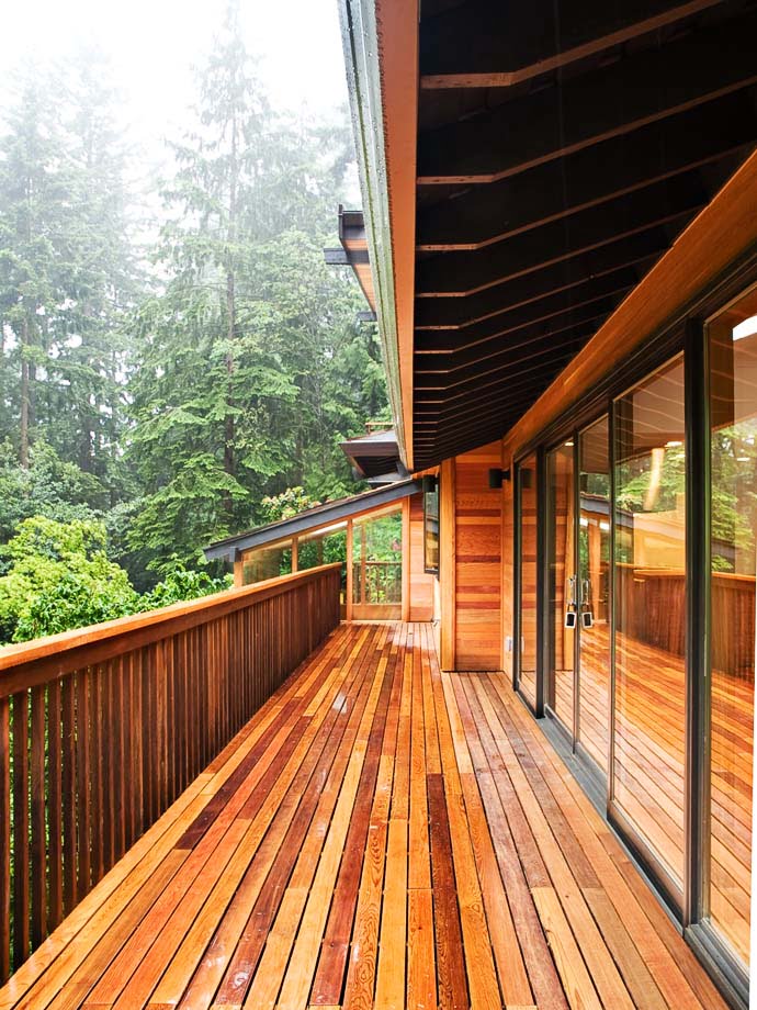 exterior balcony wrapped in wood Green Modern Classic House by PLACE Hidden in the Forest