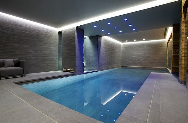 Minimalist Indoor Pool Design with Grey Walls and Recessed Lighting