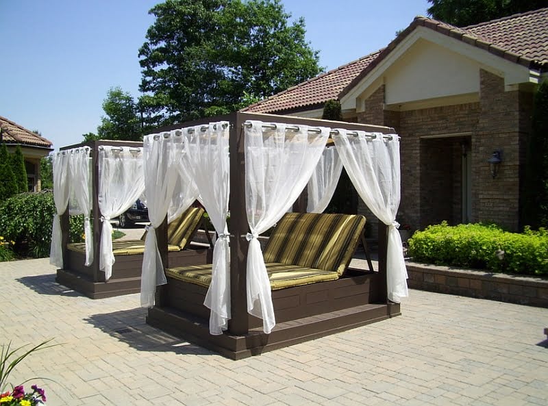 Twin Poolside Canopy Beds Enhancing Summer Evenings