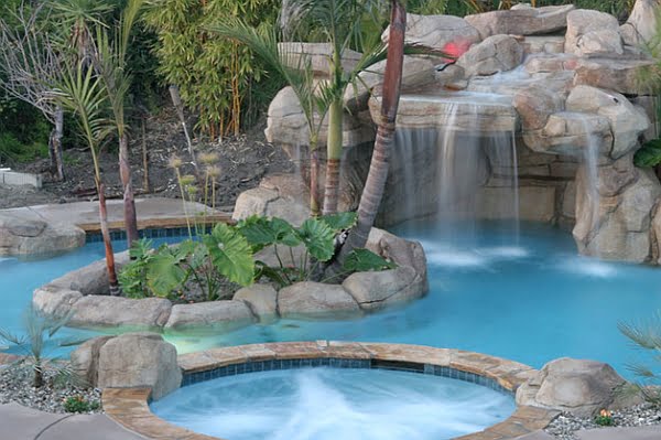 Simple Hot Tub Positioned Above the Swimming Pool Glancing at the Waterfall