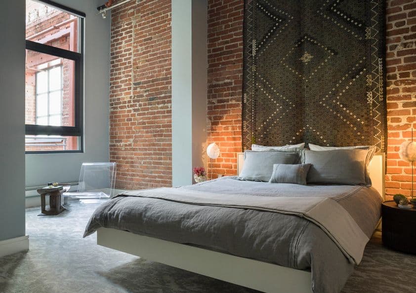 Exposed-bricks-wall-and-carpet-above-the-floating-bed