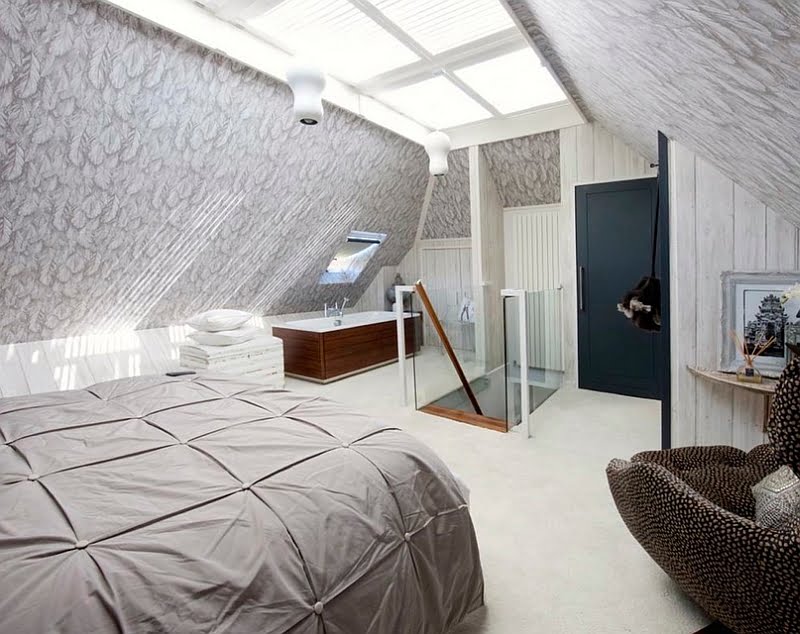 Unusual Loft Bedroom Featuring a Standalone Bathtub in the Corner