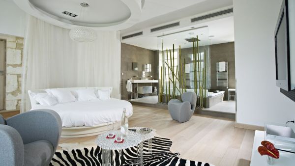 white round bed positioned in the center of this interior
