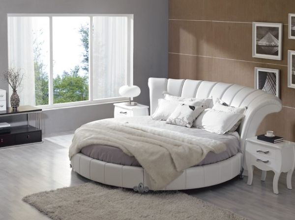 Pastel bedroom with white leather round bed.