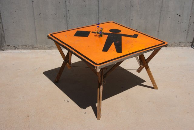 Using a road sign for a table can be a statement, but also an interesting piece of furniture that will brighten up your room. You can use a customized sign for effect . 