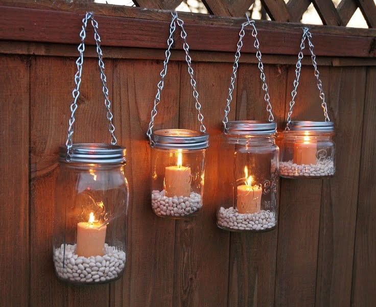 13. Hang mason jars in your backyard and light candles in them for a romantic atmosphere