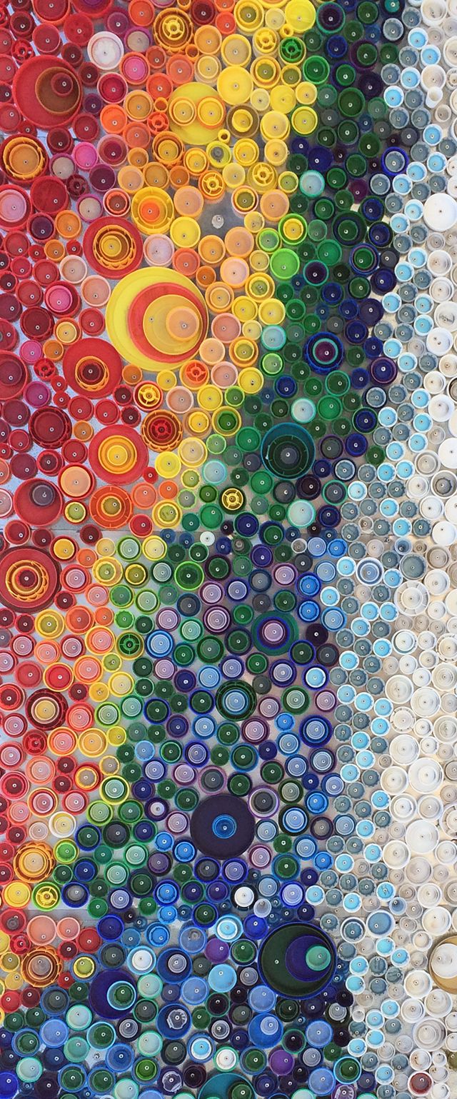 rainbow colored bottle cap art installation