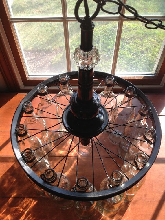 super cool glass bottle chandelier realized with a bicycle rim
