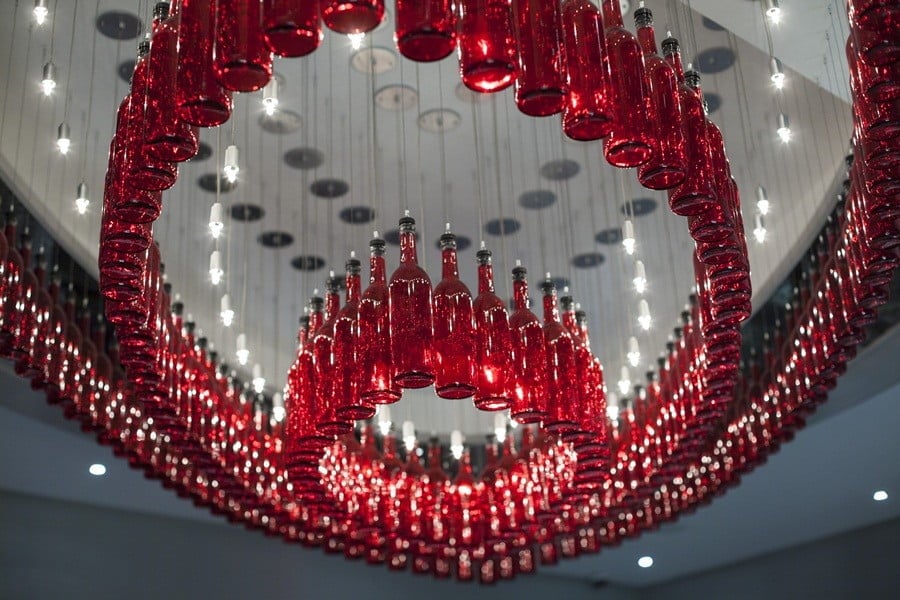 red glass bottle installation with lighting homesthetics.