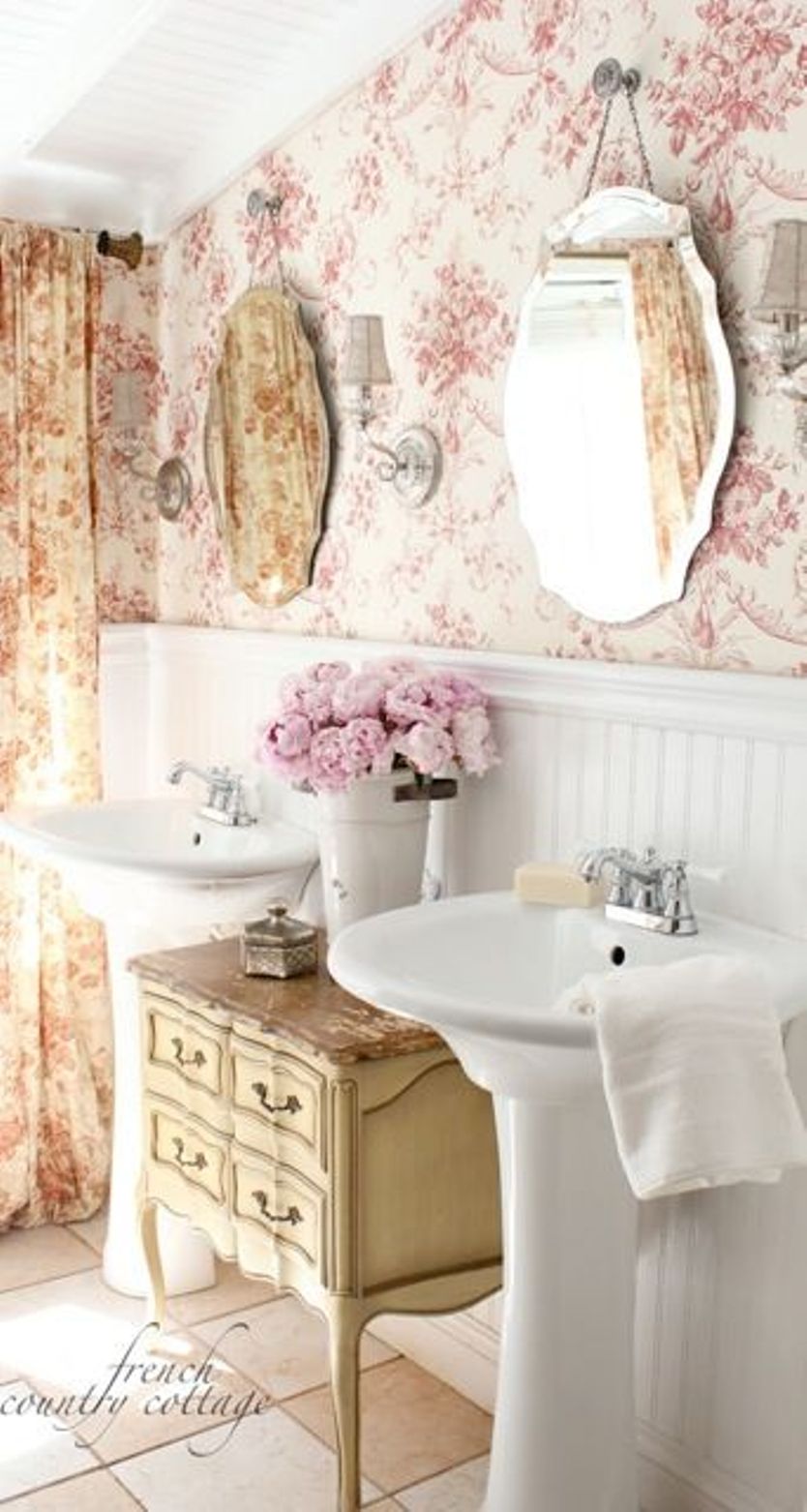 small-bathroom-makeovers-with-wainscoting-and-wallpaper-and-vintage-cabinet-between-two-pedestal-sinks-and-mirrors-and-flower-style-curtain