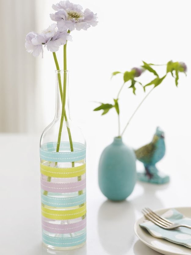 Use washi tape to decorate wine bottles as flower vases