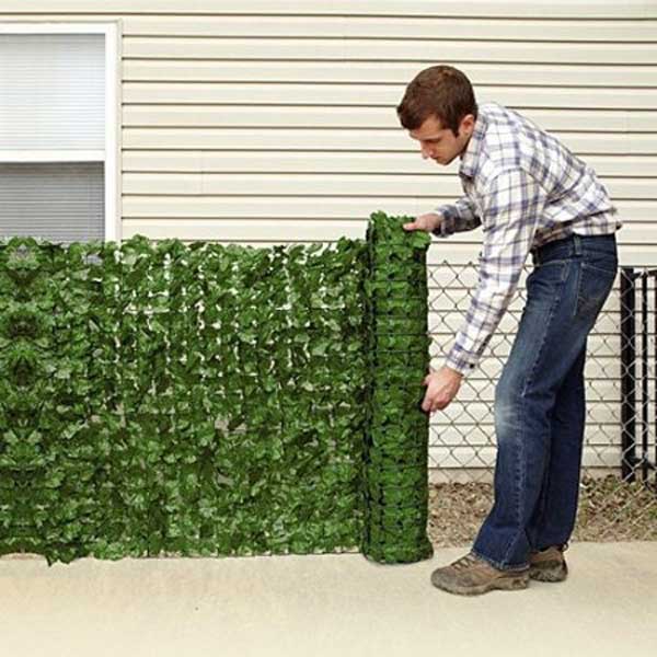 12. FAUX GREEN PRIVACY SCREEN MOUNTED ON A WIRE FENCE