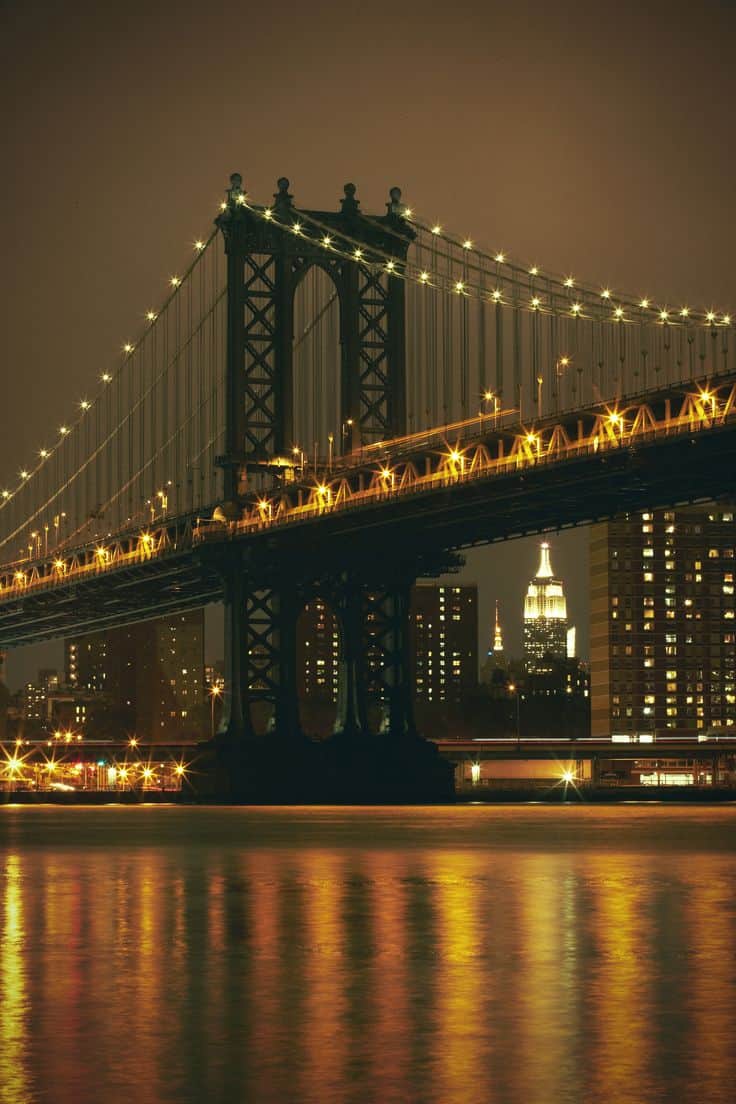 #11 The Brooklyn bridge at night standing over the east river in New York