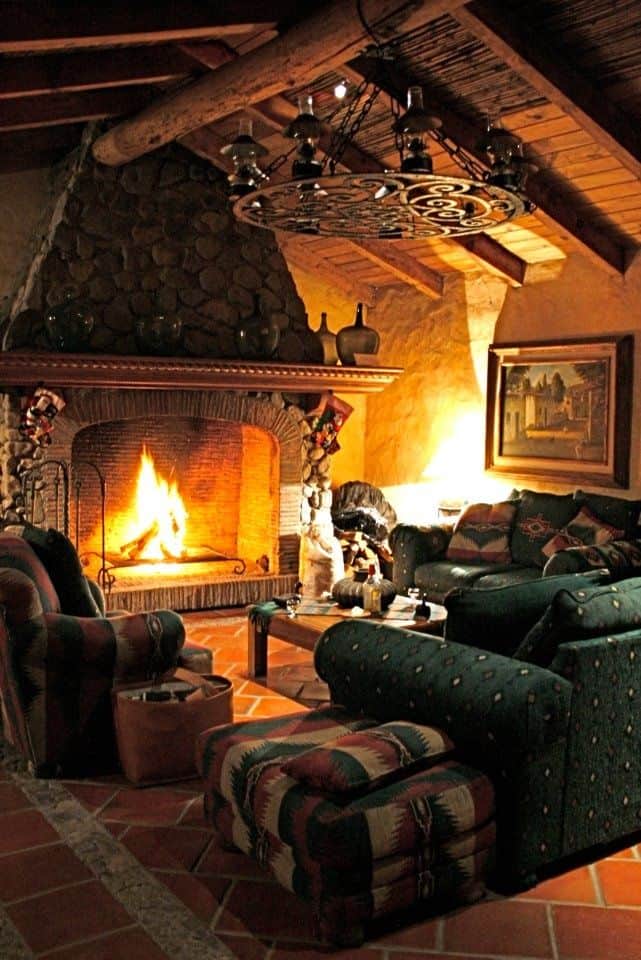 #35 GREEN SOFA AND FLAMING FIREPLACE IN THIS LOG CABIN