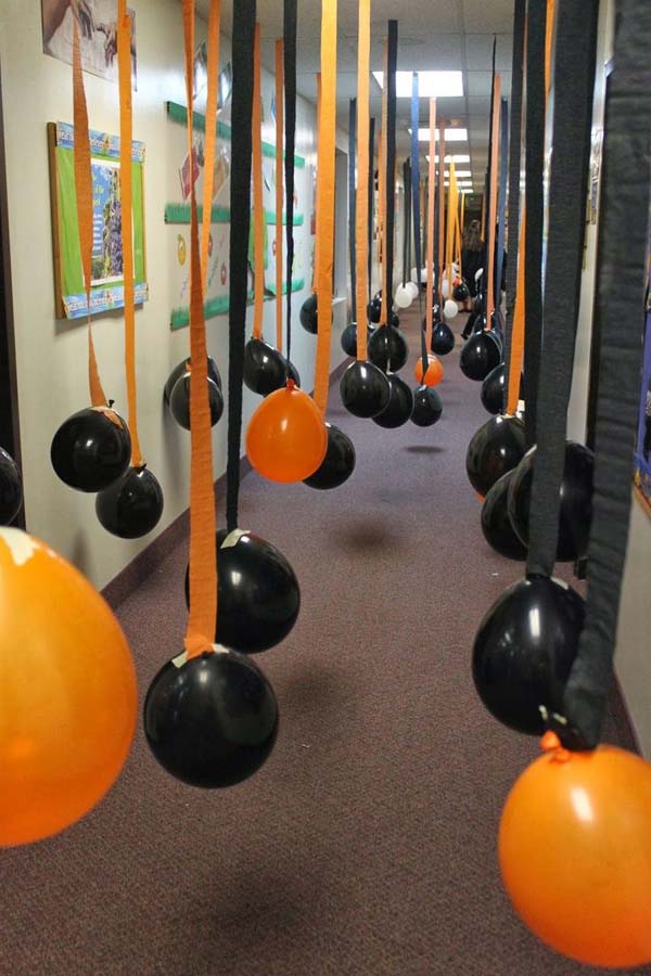 #42 ORANGE AND BLACK BALLOONS DECORATING A SCHOOL HALLWAY