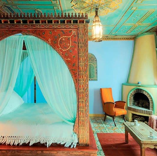 #13 give a canopy bed an Asian design by contrasting a feminine soft silk turquoise drape against  a masculine orange brown bed frame