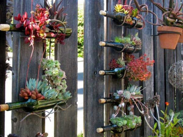 13. use wine bottles as horizontal fence suspended gardens