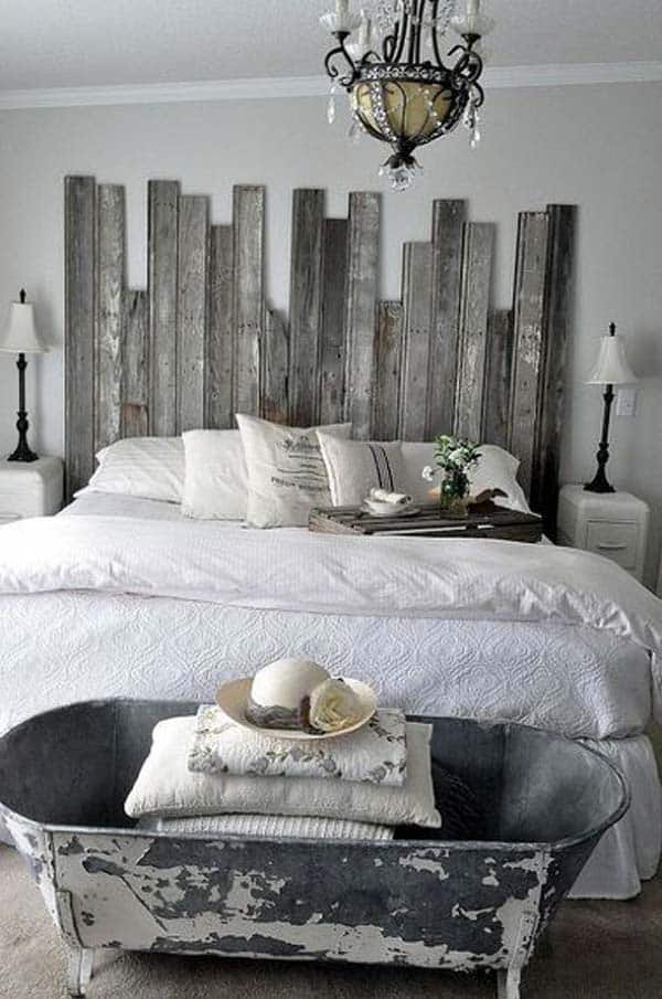 COOL BEDROOM DECOR WITH OLD BATHTUB AT THE FOOD OF THE BED AND PALLET HEADBOARD