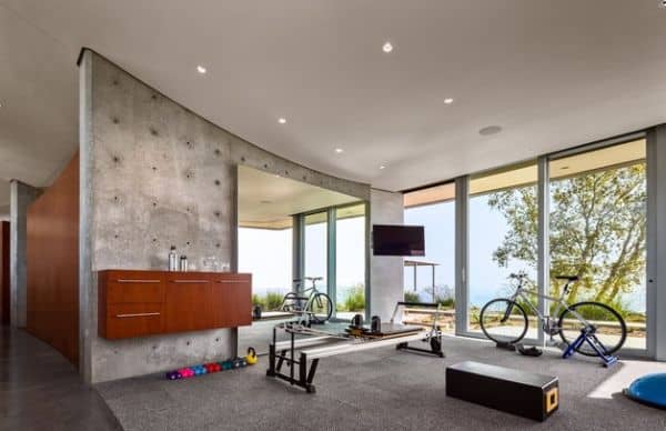 An industrial home gym design with expansive views.
