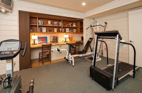 Neat home office inserted into a closet in the gym.