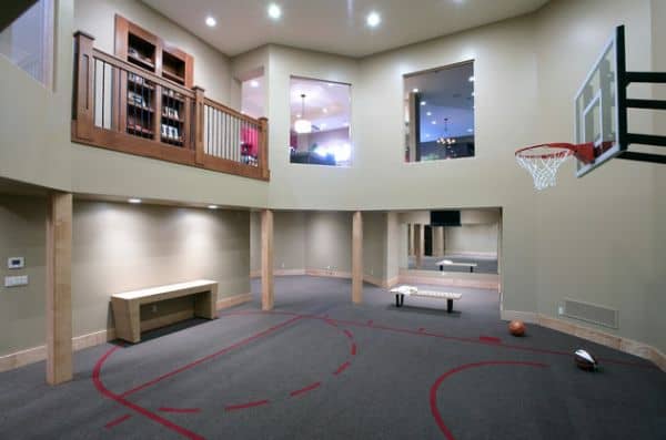 Impressive home gym in the basement with carpeted basketball courtyard
