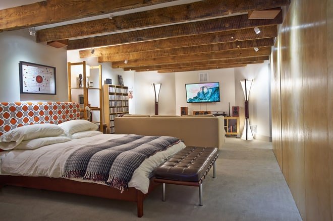 exposed wooden beams enhancing a basement bedroom