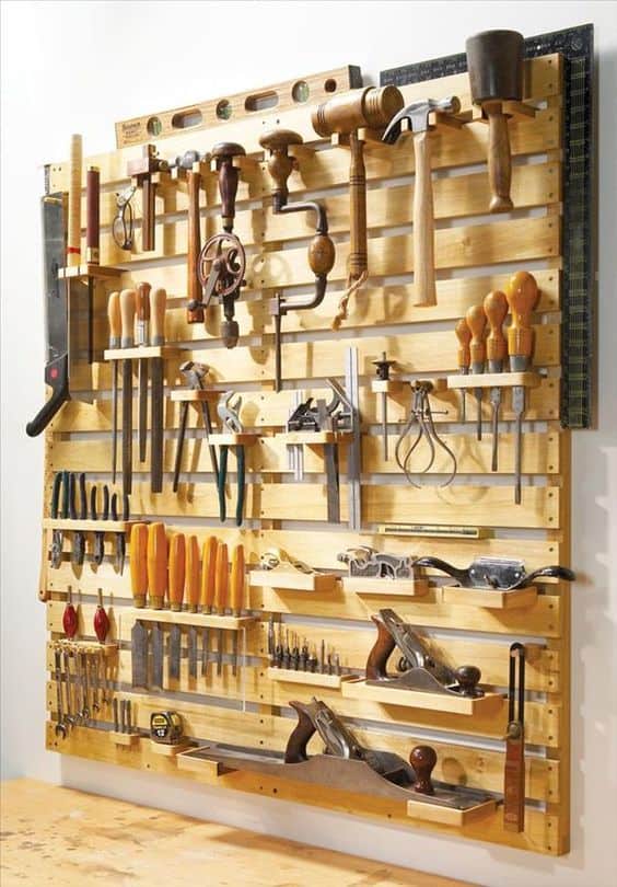 #10. WOODEN PALLETS ASSEMBLED INTO A MUTLI-FUNCTIONAL WALL FOR THE GARAGE