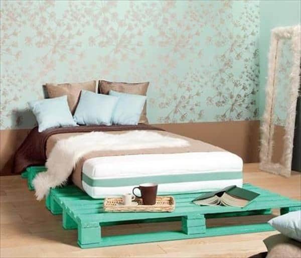 12. BRIGHT NEON GREEN PALLET BED ADORNED ON A GOLD AND GREEN WALLPAPER BACKGROUND