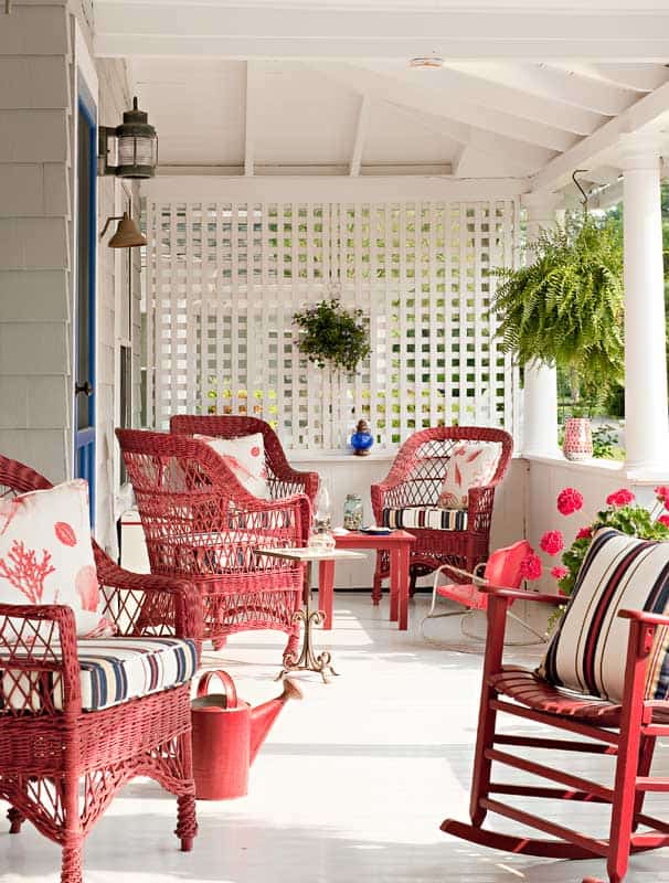 red wicker patio set nestled in stark white