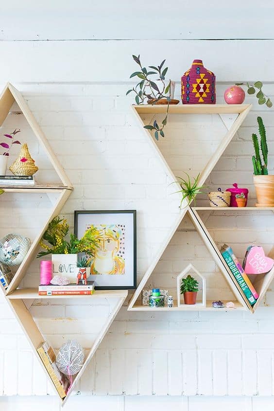 geometric wooden shelving on white brick wall