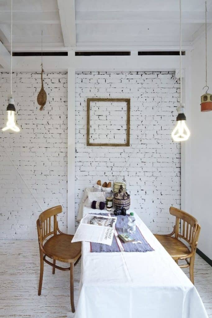 industrial white stark interior design with painted bricks