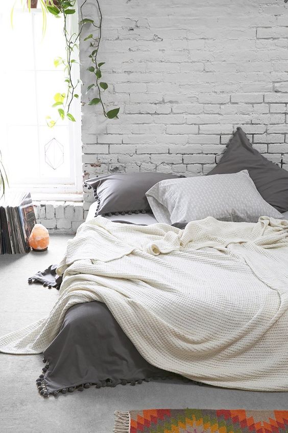 shabby chic industrial bedroom with white brick wall