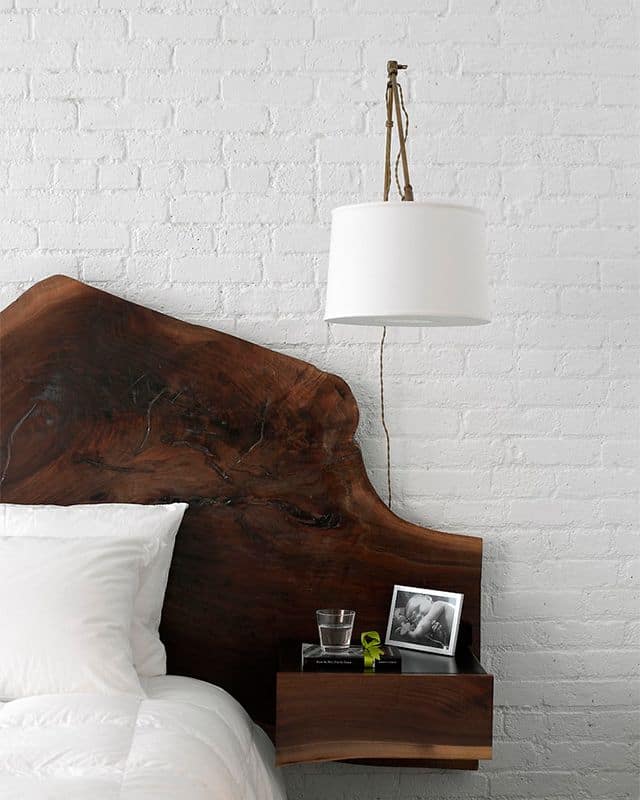 wooden headboard doubled by white bricks on the wall