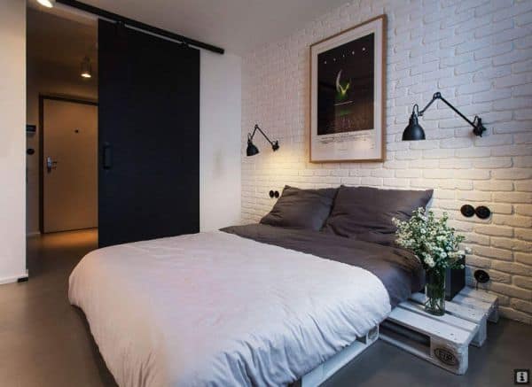 chich bedroom with wooden bricks, barn door and wooden pallet bed