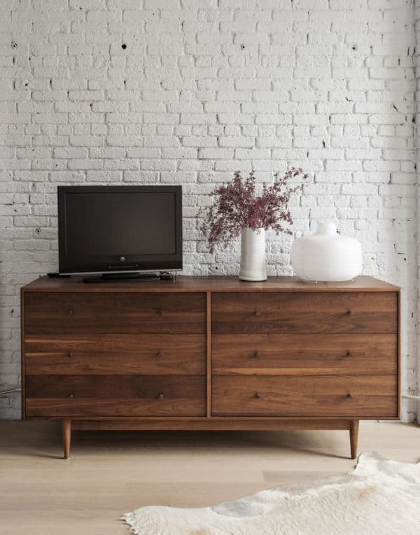 walnut furniture on a white background of brick