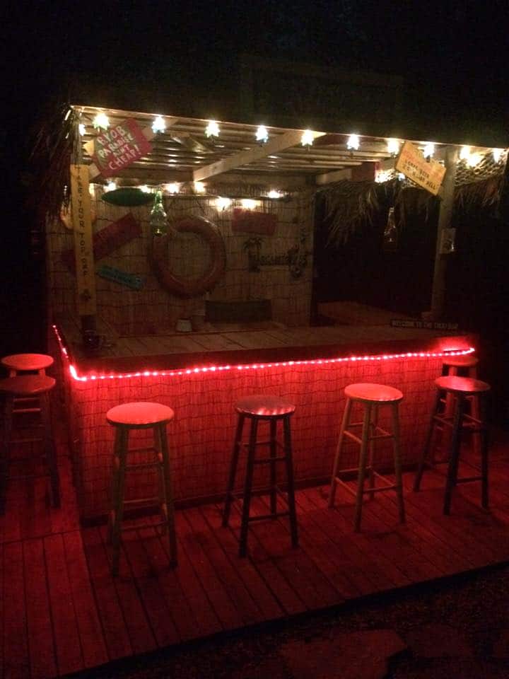bar made of pallet and decorated with LEDs and light bulbs